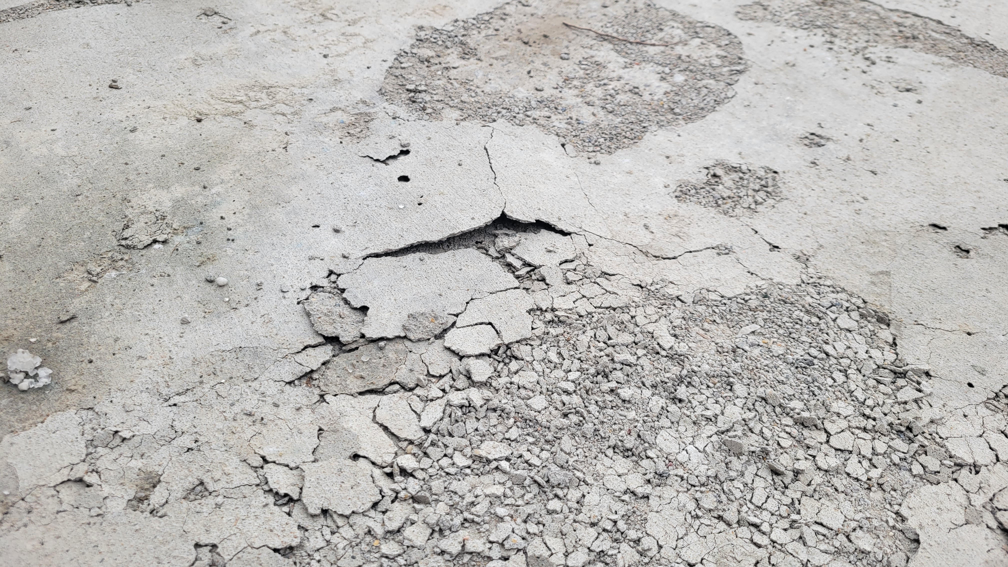 stapes concrete and grading distressed driveway